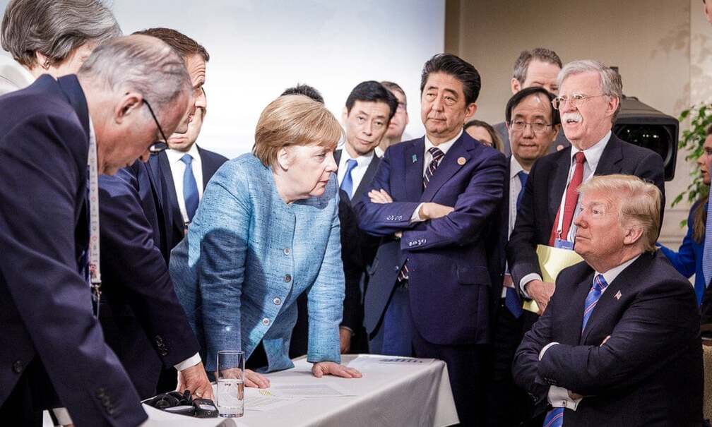 Angela Merkel gives Trump a look.